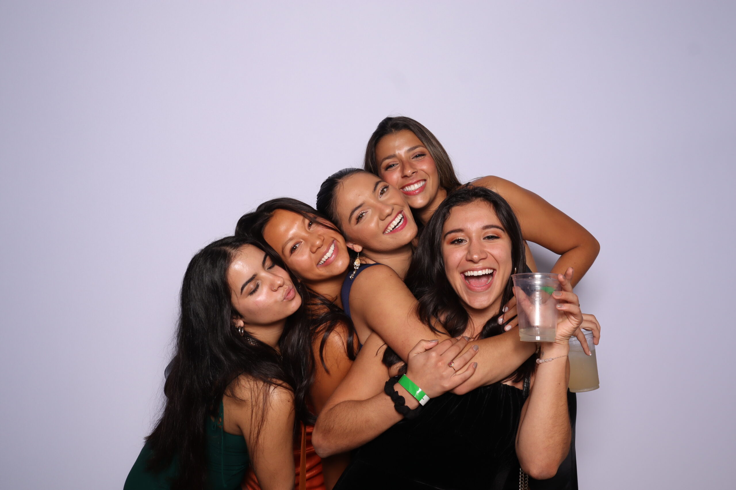 Photo Booth Rentals for Quinceaneras:Quinceañera with friends in velvet-themed photo booth