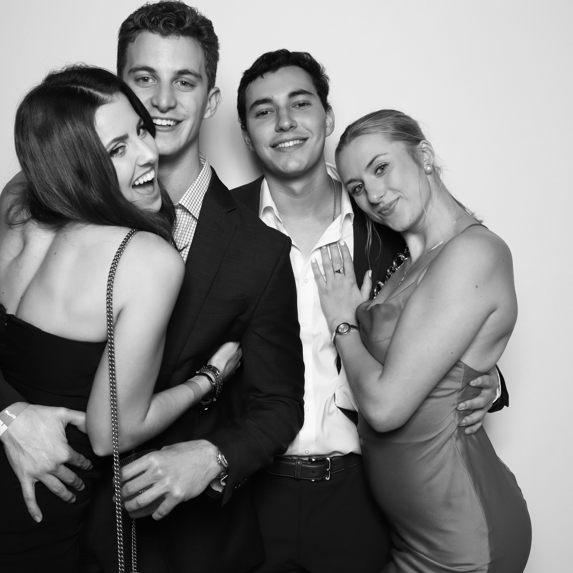 How Much Are Photo Booth Rentals for Weddings. Couple smiling in front of a custom wedding photo booth backdrop