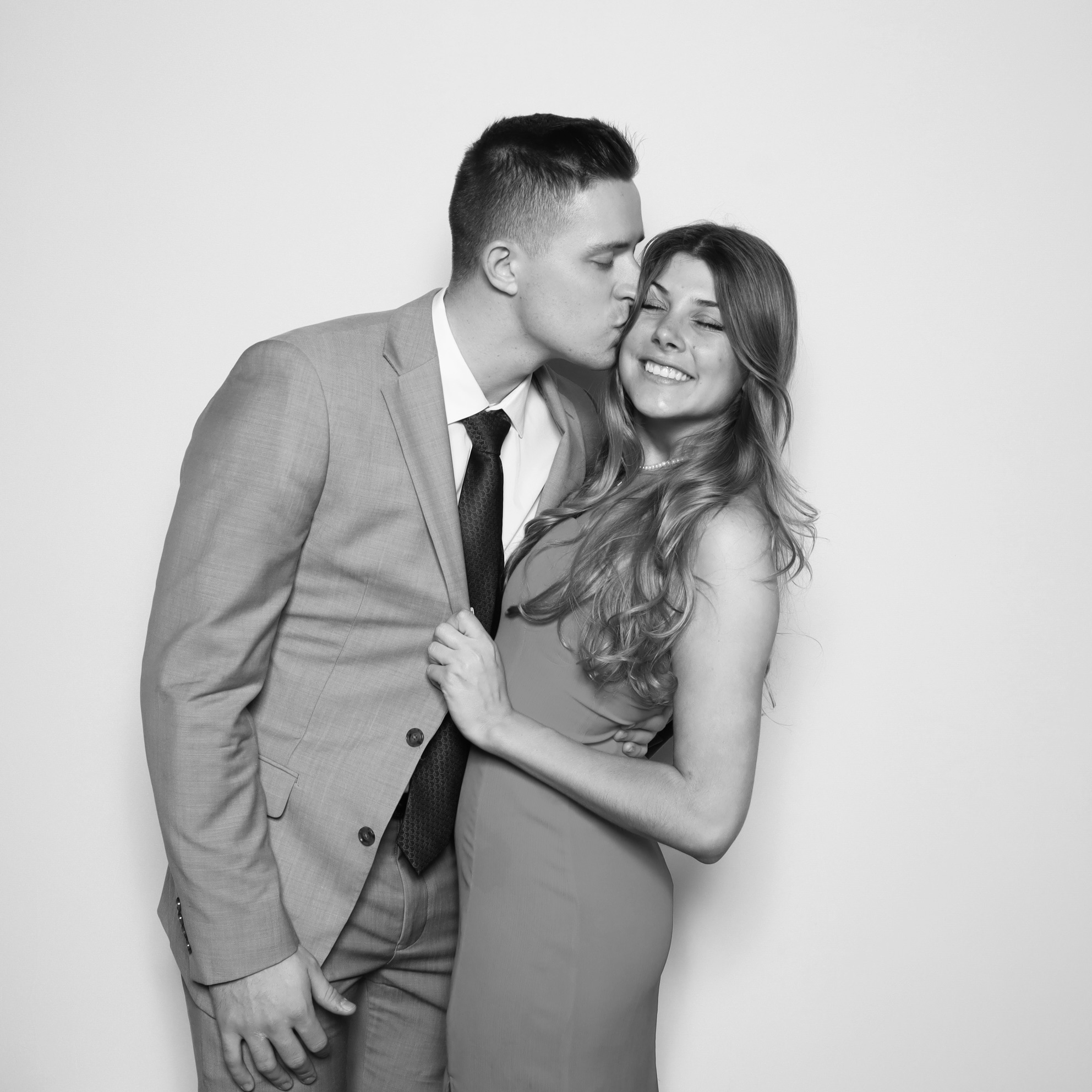 Wedding Rentals in Orlando - Bride and groom laughing in front of a custom photo booth backdrop in Orlando