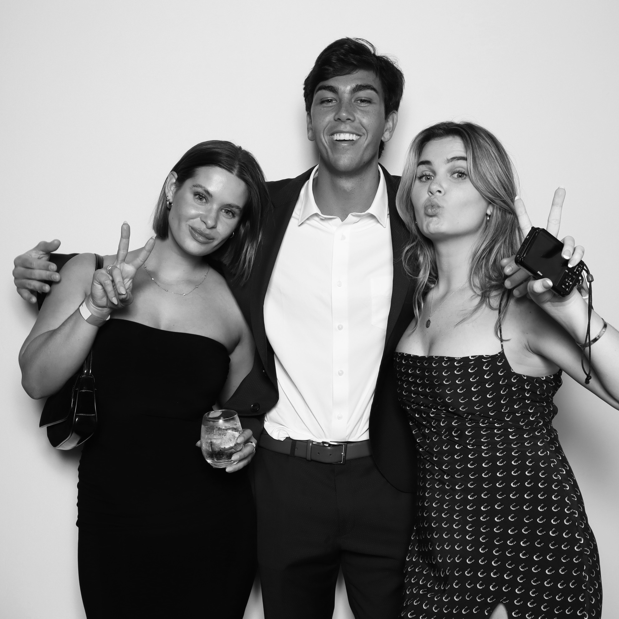 Couple posing with printed photo from a stylish photo booth rentals in Orlando