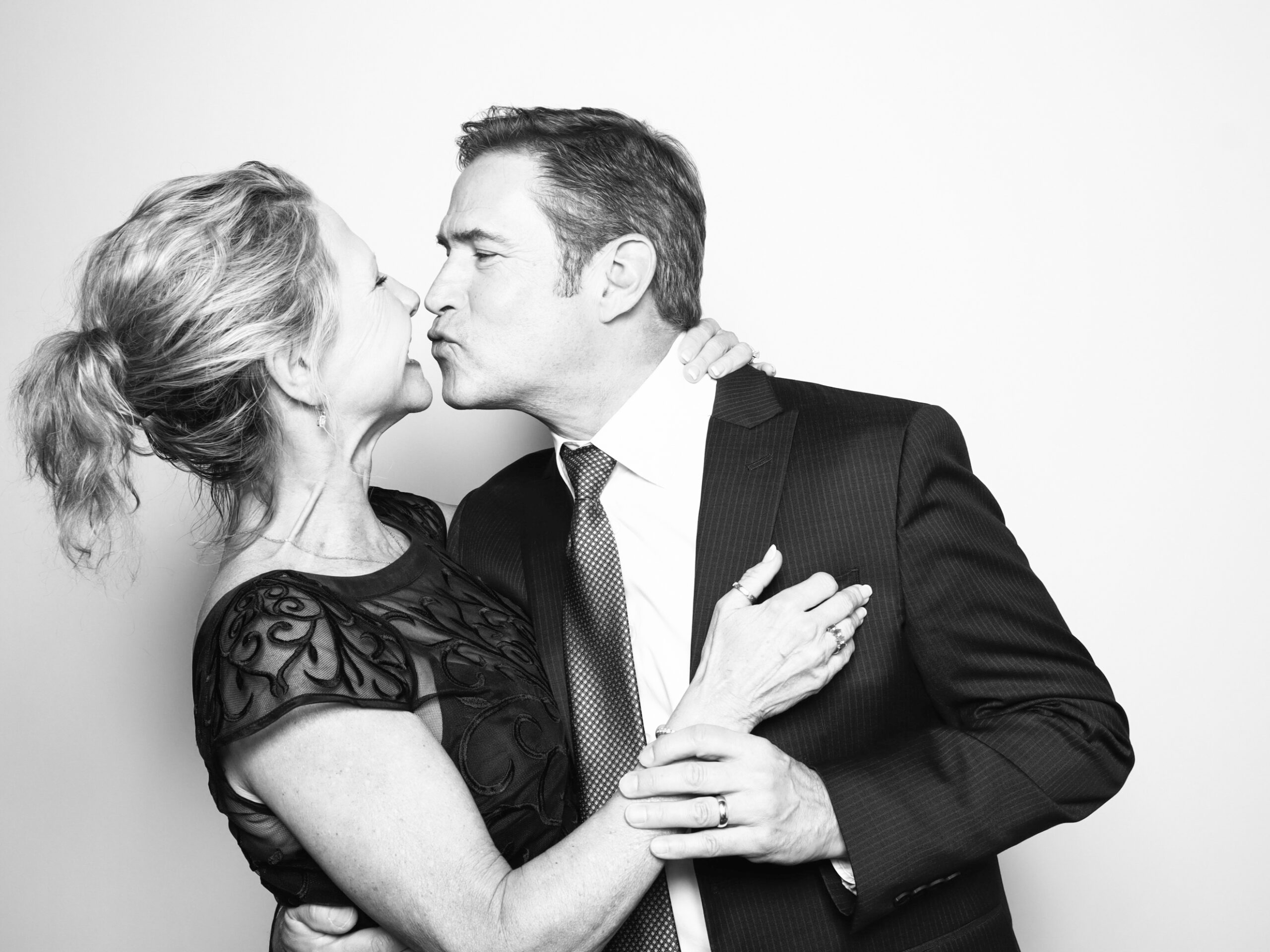 How Much is a 360 Photo Booth Rental? Guests laughing on a 360 photo booth platform during an upscale wedding in Orlando