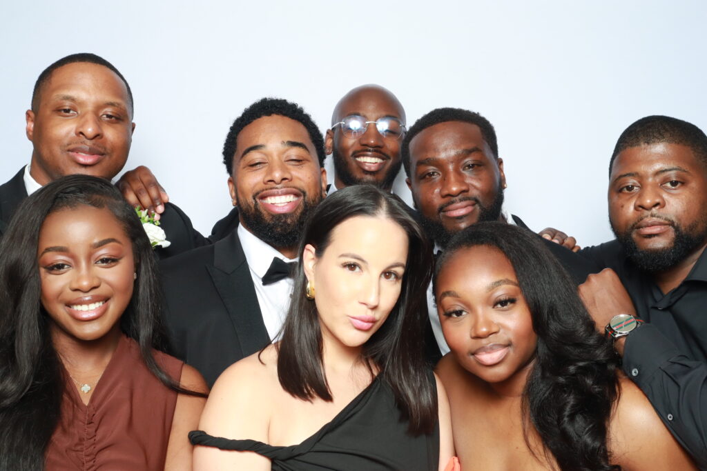 Corporate event guests using branded props in a modern photo booth rental setup