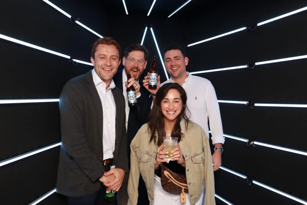 Adult guests at an upscale birthday party using a 360 photo booth
