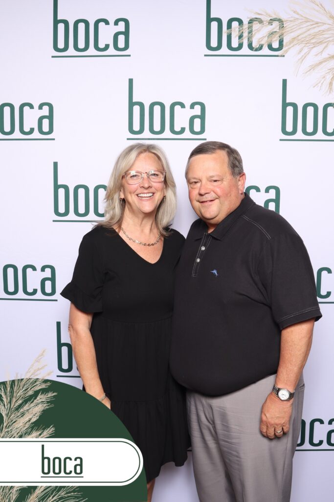 Corporate event attendees using a branded photo booth with prints