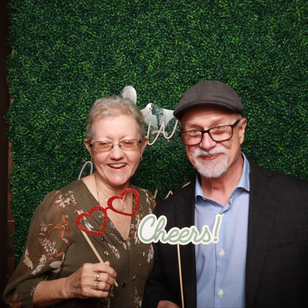 Group of friends using a photo booth at a corporate event

