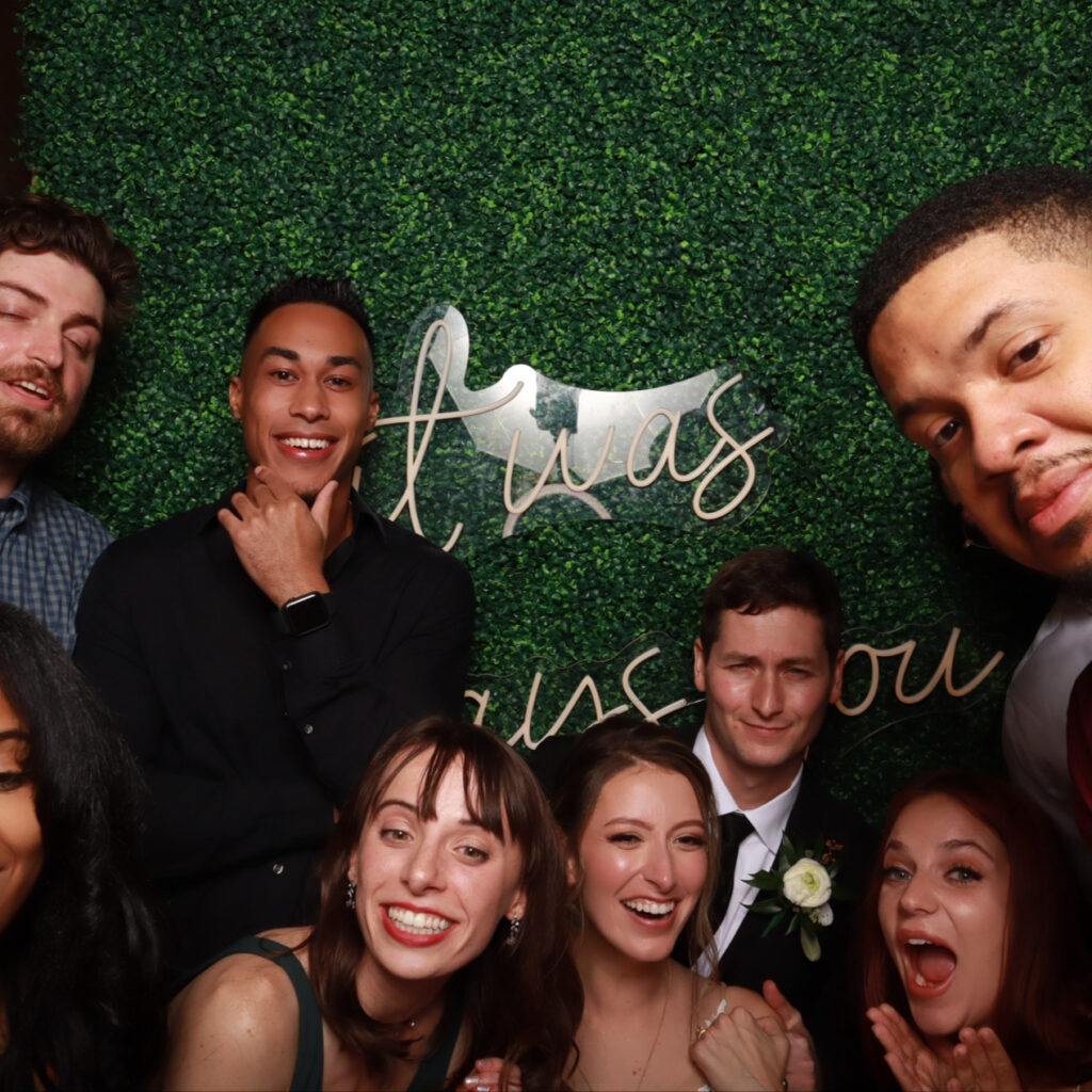 Elegant wedding guests capturing memories at a Strata Booth selfie station