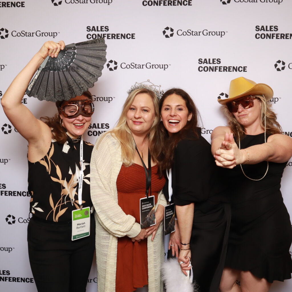 Group enjoying a branded photo booth experience during a corporate event in Orlando, FL