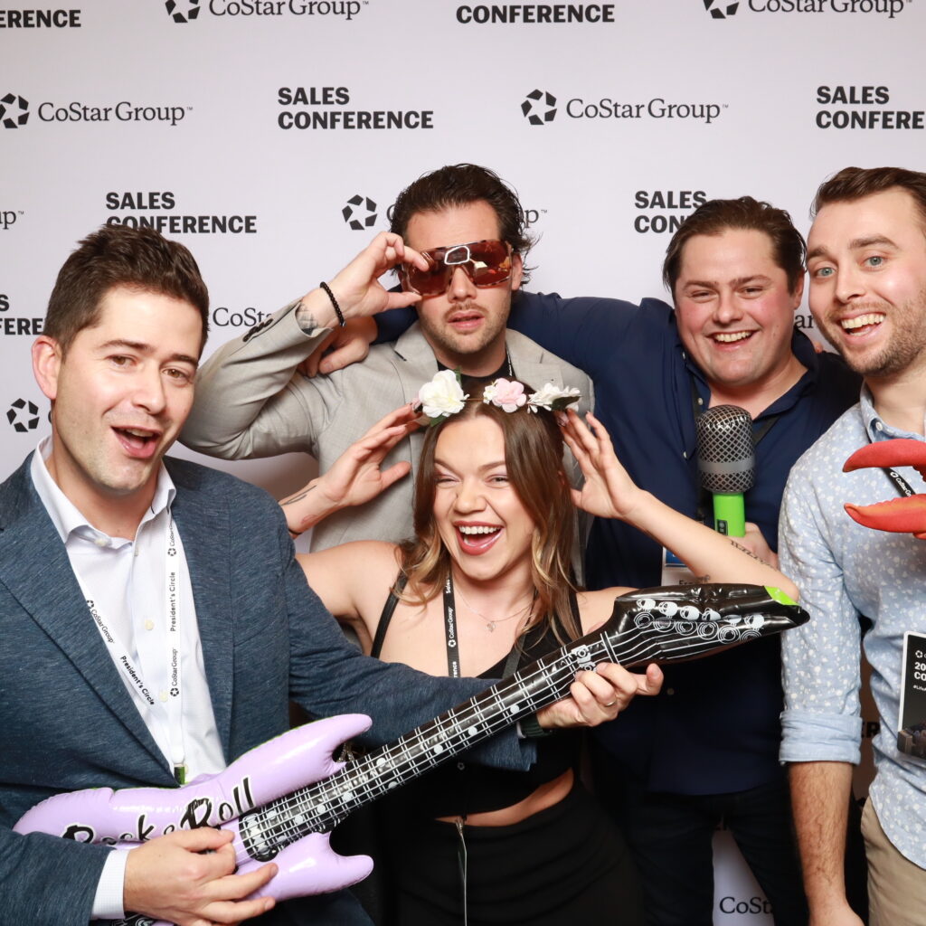 Orlando corporate photo booth with team group shot during CoStar sales conference welcome reception