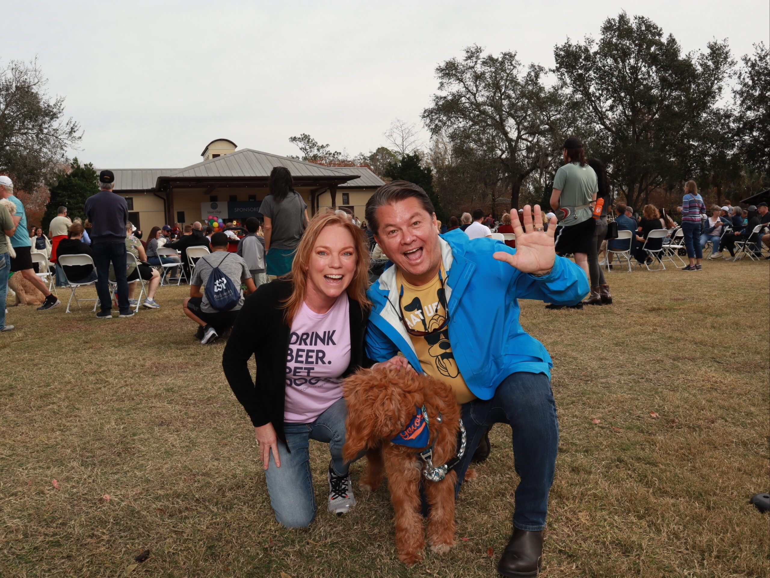 Couple posing with dog at Pups and Pints Celebration FL Photo Booth