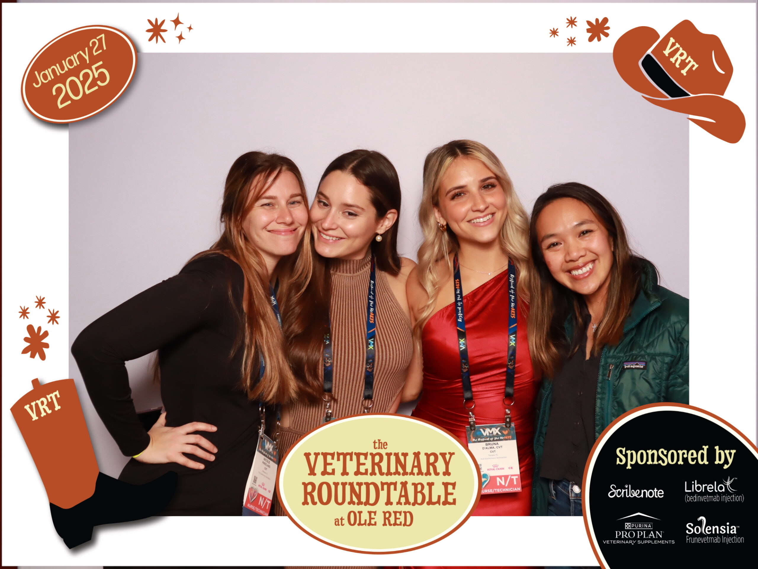 Four attendees posing in front of the Veterinary Roundtable Live Podcast VMX 2025 Photo Booth