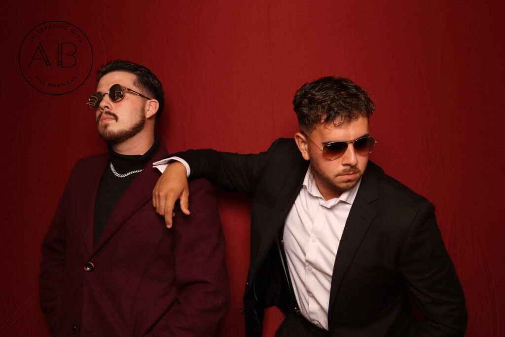 Two men in suits wearing sunglasses posing with attitude in Lake Mary photo booth rental