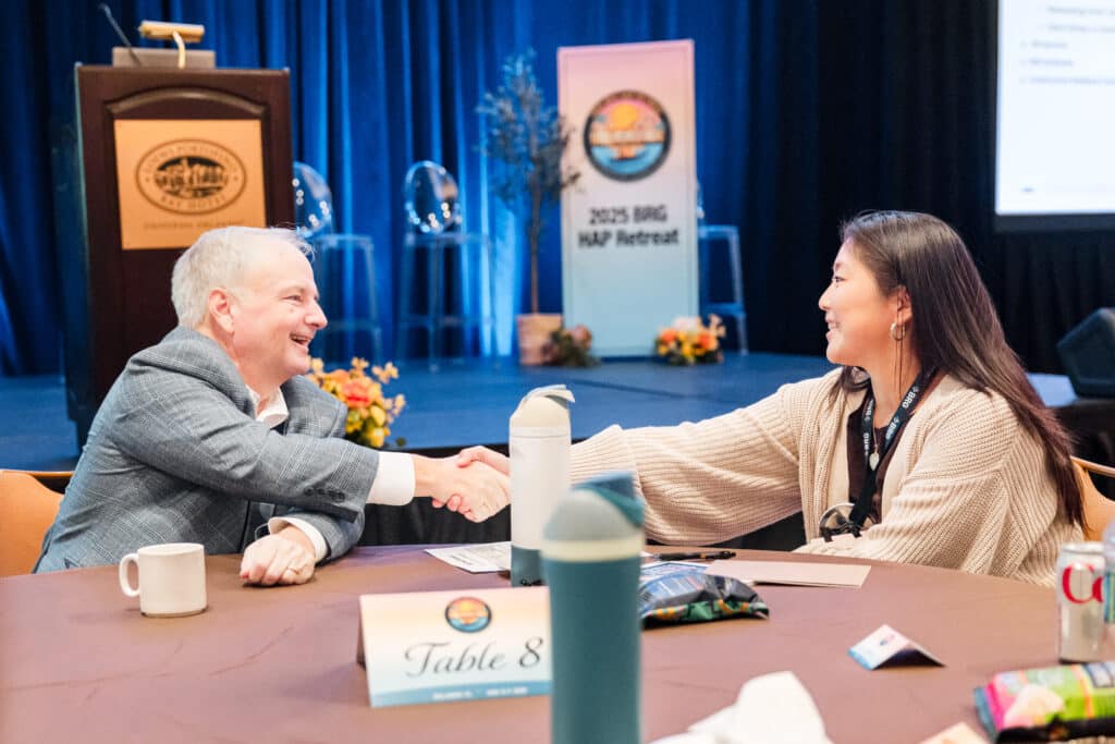 Keynote speaker presenting on stage at a corporate event